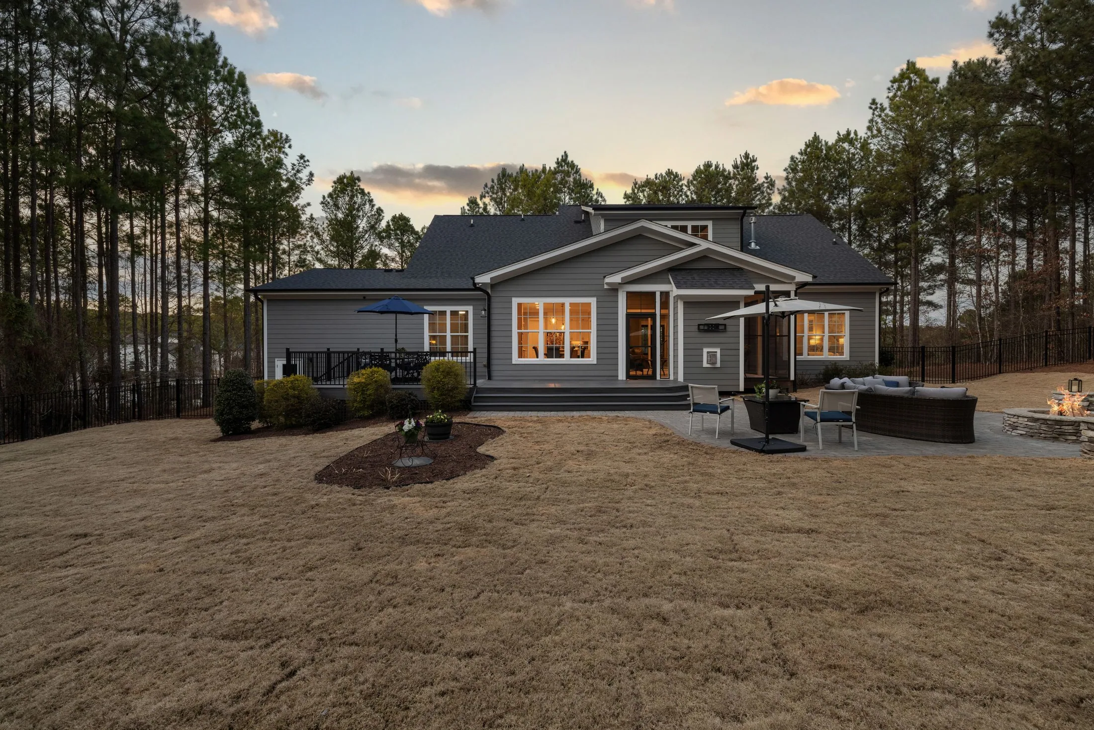 Home and outdoor gathering space at dusk