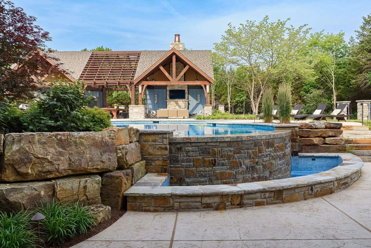 An outdoor environment composed with stone, water, timber, and planting